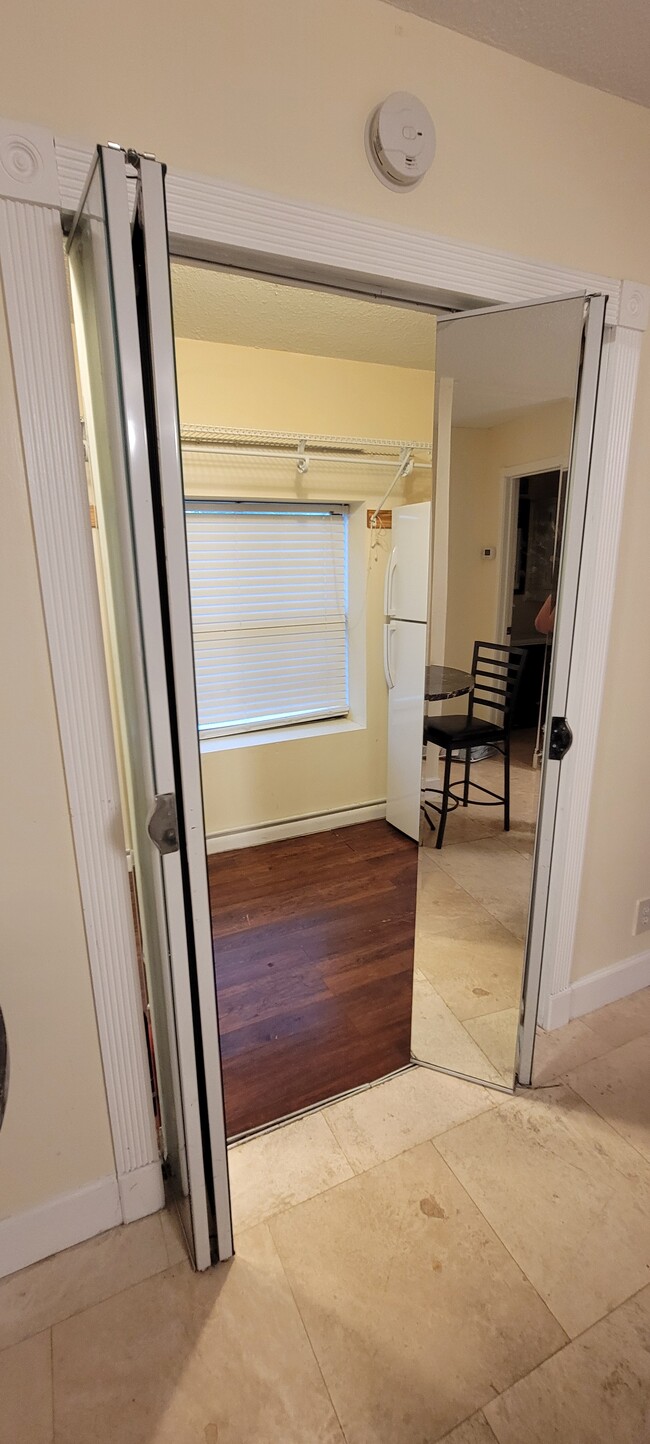 Mirrored entry into large walk-in closet / kitchenette area. - 9070 Kimberly Blvd