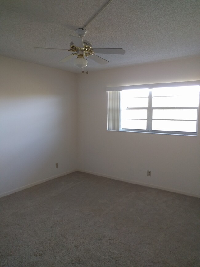 Front guest bedroom. New carpet. - 198 NW 67th St