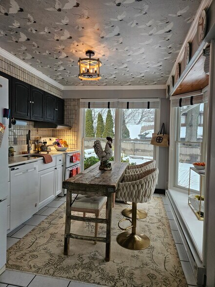 side yard view in kitchen with table facing Bay - 1301 Rogers Rd