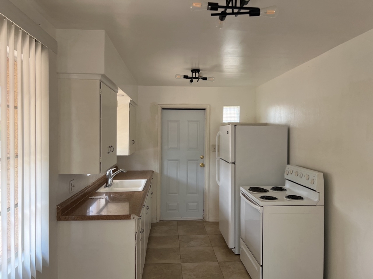 KITCHEN + DOOR TO SMALL FENCED PET AREA - 6210 N 12th Pl