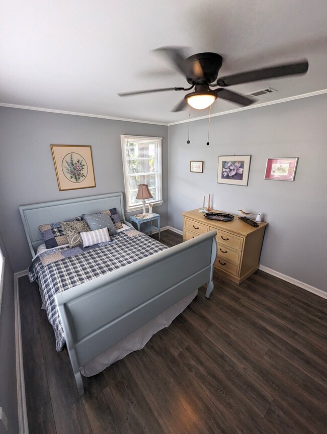 Bedroom 2 is warm and cozy. Queen bed, original art and a closet. - 4107 Crane St