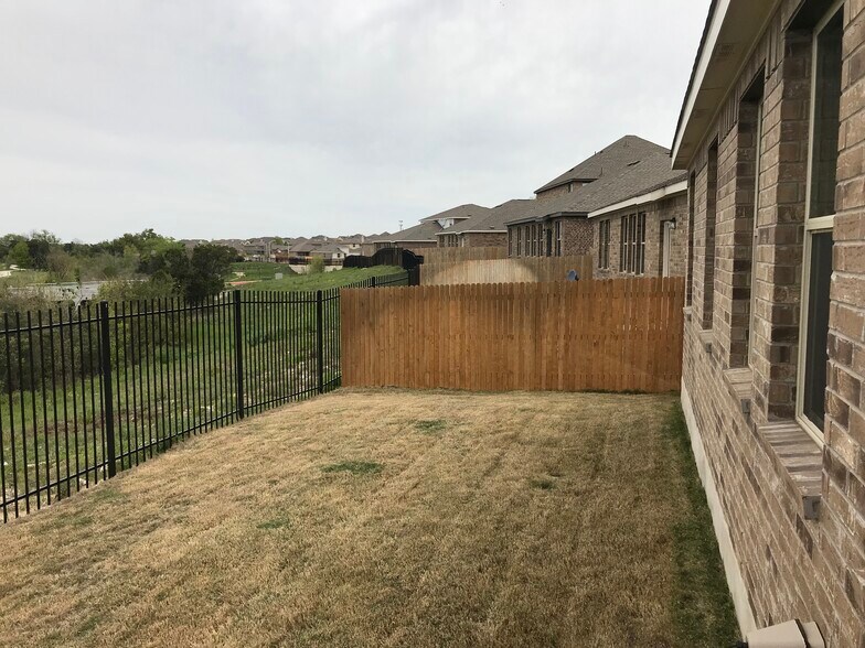 Privacy fence and greenbelt creek that seperates the house from the neighbors in the distance. - 1313 Eagle Ridge Trl