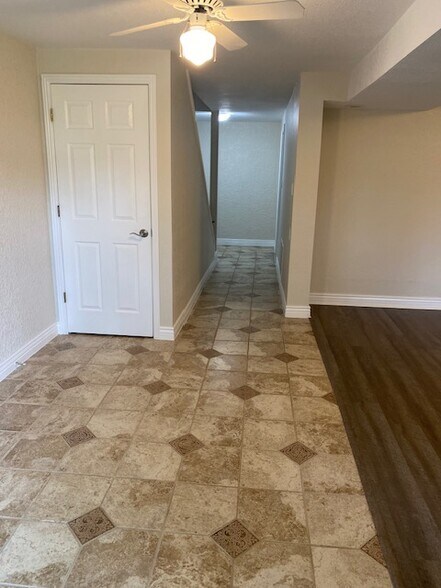 Lower level living, storage closet under stairs. - 411 E Highline Cir