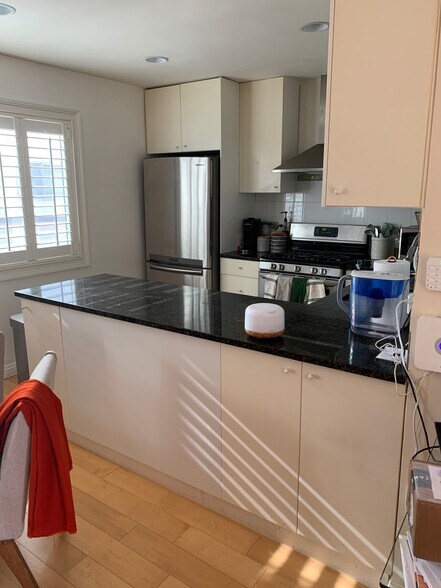 Bright Modern Kitchen with Stainless Fridge, Hood, Marble Counter top - 2444 4th St