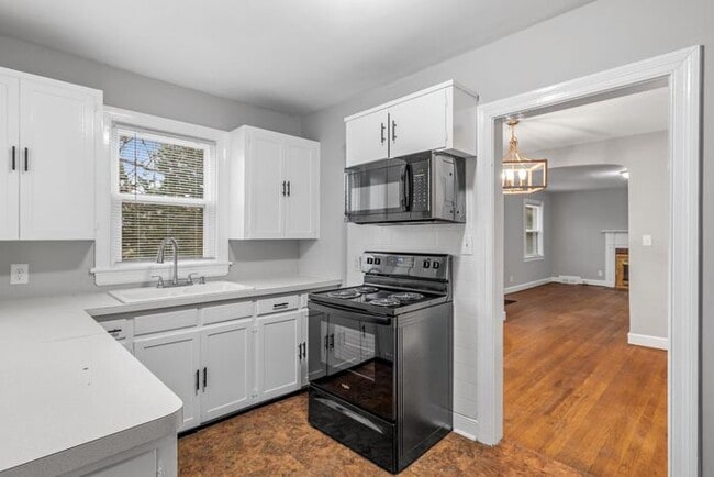 Building Photo - Brick home, Two Story, Hardwoods, DR, 2 Sun Rooms, FP, Carport!.