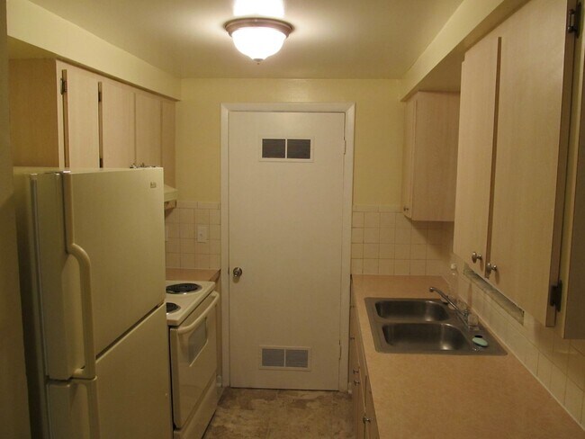 Building Photo - Three bedroom one and a half bathroom house with large yard space