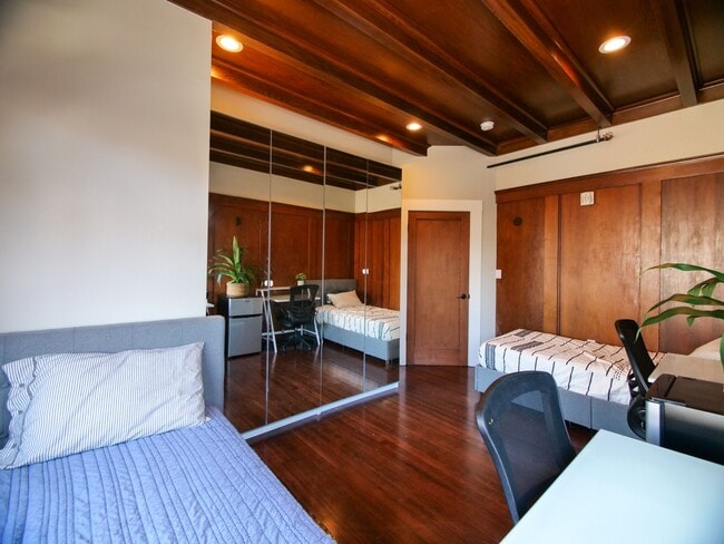 A thoughtfully designed bedroom with hardwood floors, cozy beds, and workspace for you. - 2901 Channing