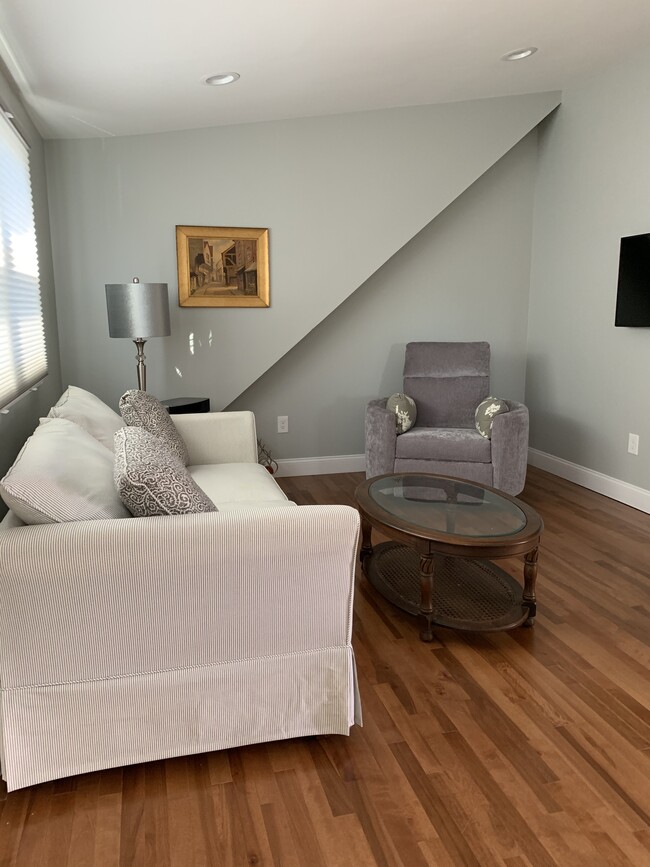 Living Area with couch, swivel recliner, television and radio/ CD player. - 97 Washington street