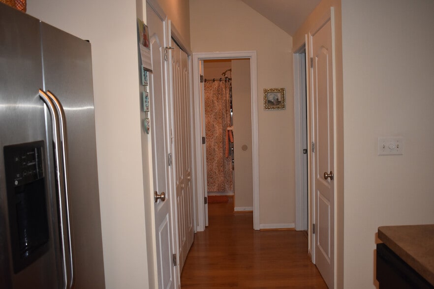Hallway with pantry, laundry room, bathroom, and 2nd entrance to master bedroom - 1007 RIVERS ARCH