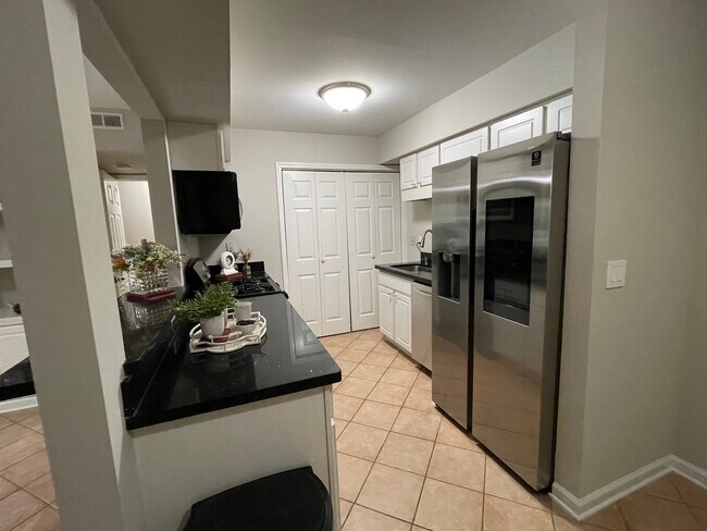 Kitchen contains a gas stove, microwave, smart fridge, and washer/dryer - 1312 Hillbrow Ln