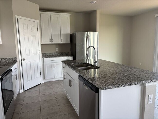 Building Photo - Like-New 4 Bedroom 3 Bath with Pond View & Two Living Spaces — Minutes to South Lake Nona