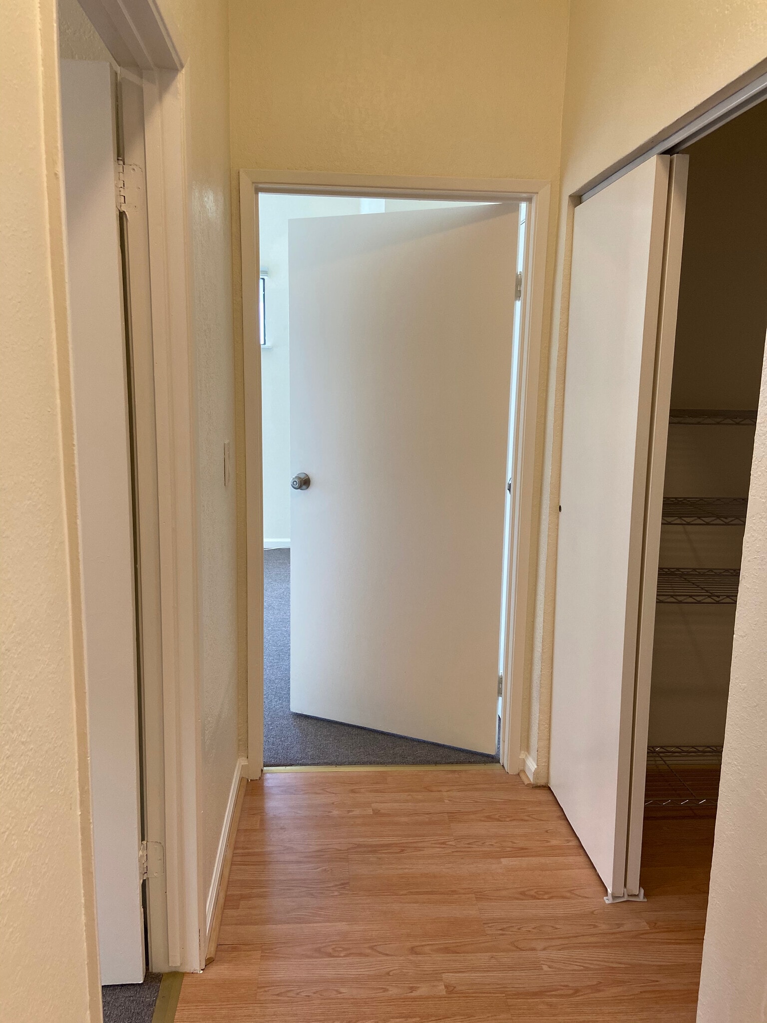 Hallway with extra storage space and 20 foot skylights - 4179 Shafter Ave