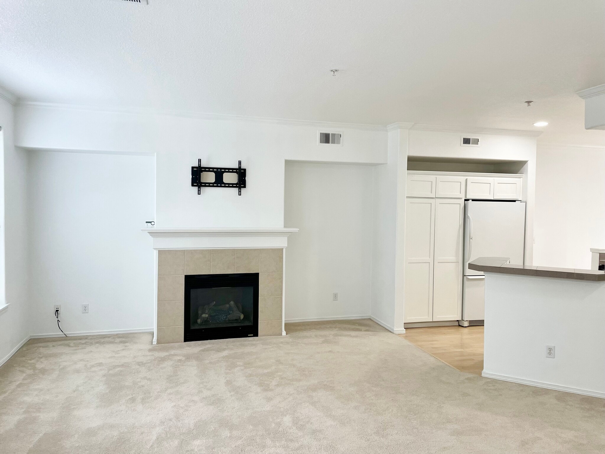 Open floor plan with gas fireplace and TV hookup - 10245 NW Wilshire Ln