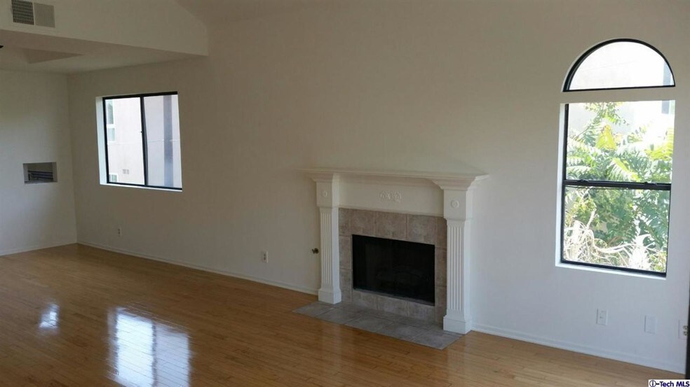 living room with vaulted high ceiling and view of the mountains - 14572 Dickens St