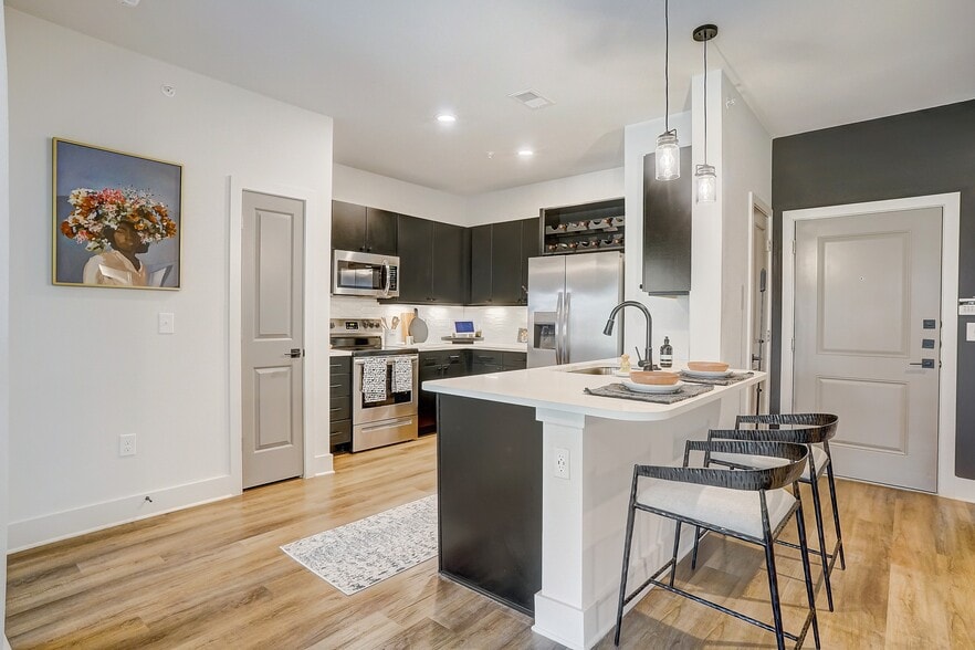 Kitchen with Quartz Countertop and Stainless Steel Appliances. - The Parian Mooresville