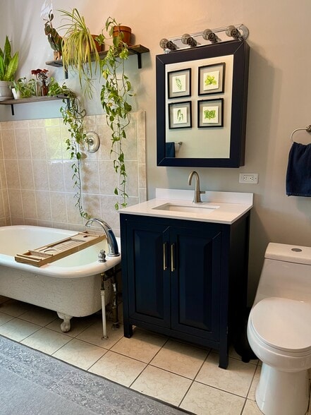 The cast-iron tub is original, but the other fixtures have been updated. - 5142 S Greenwood Ave