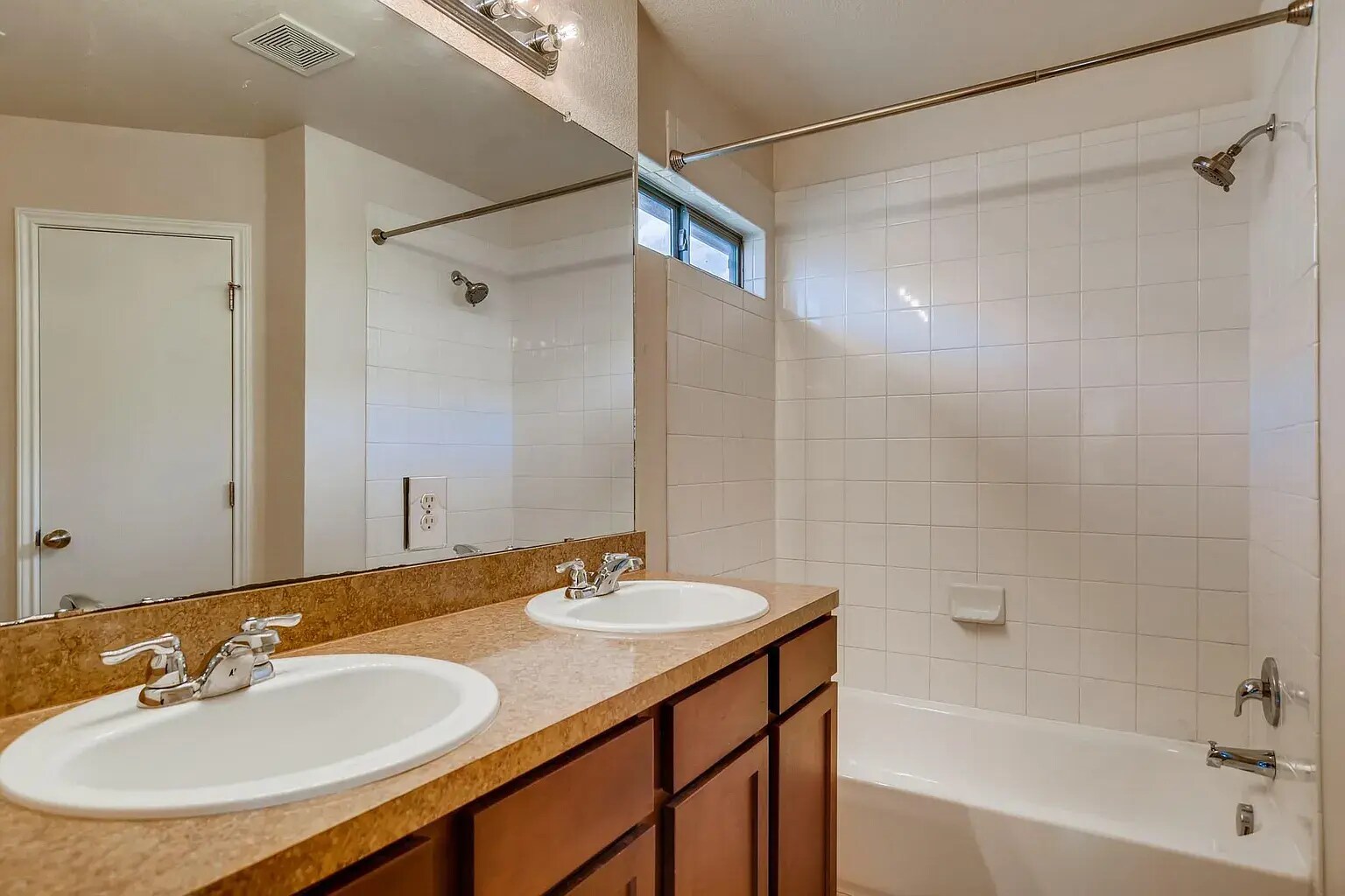 Second full bathroom comes with a bathtub and two sinks! - 15106 Parrish Ln