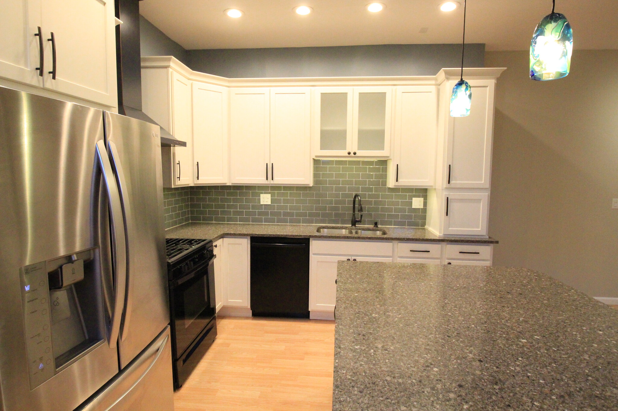 Gorgeous updated kitchen boasting quartz countertop, massive island w/seating, tile, extra tall cabs - 4536 Leo Street