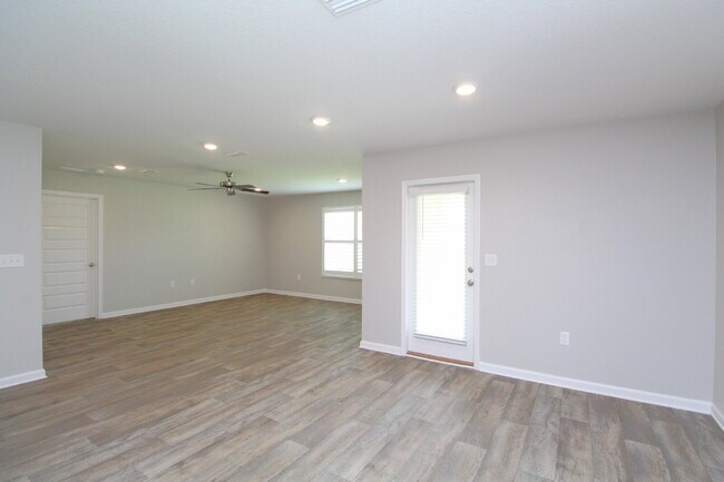 Building Photo - Coming Available Soon – 4BR/2BA Brick Home with Open Floor Plan, Solar Panels & 2-Car Garage in L...