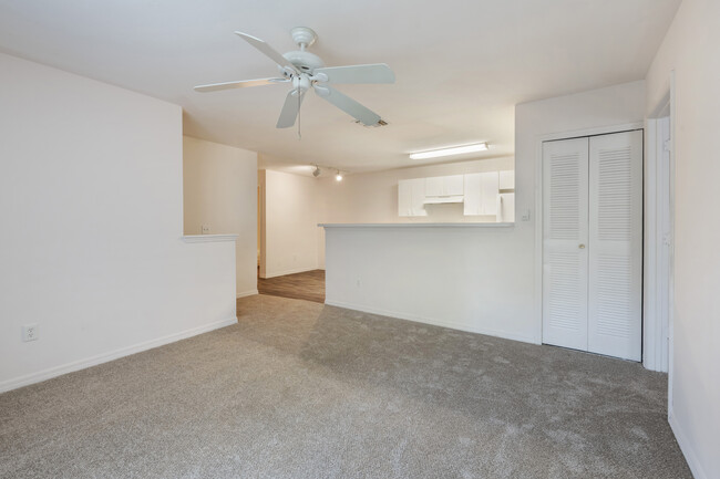 Living room with carpet flooring and multi-speed ceiling fan - Park Villas Apartments