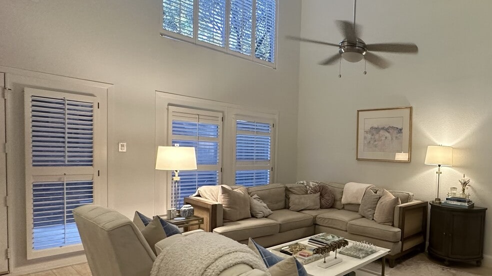Living room has a lot of natural light with 26’ vaulted ceilings - 8103 N New Braunfels Ave #5