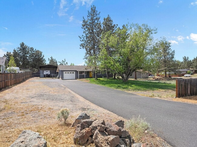 Building Photo - Charming 3-Bedroom Bend Home on 1/2 Acre with Expansive Yard, Mature Trees & Covered RV/Boat Storage