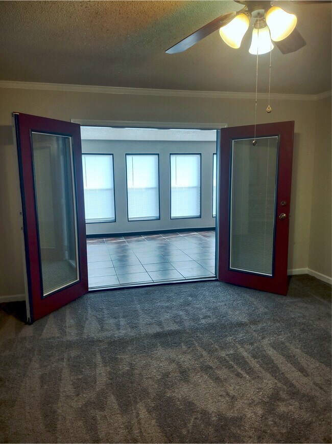 Large Master Bedroom with Double door access to sunroom with great view and track lighting. - 120 Arrow Lands Trl