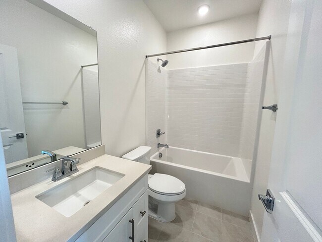 Building Photo - Gorgeous, 3 level townhome, featuring 2 car garage central Air, and in Unit laundry.