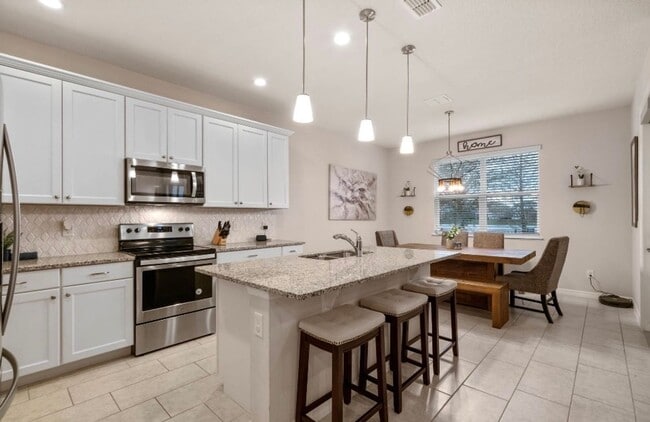 Building Photo - Water Front Home- 4 Large Bedrooms-3 baths Gated Community Call Sheila Campbell 407-687-7900
