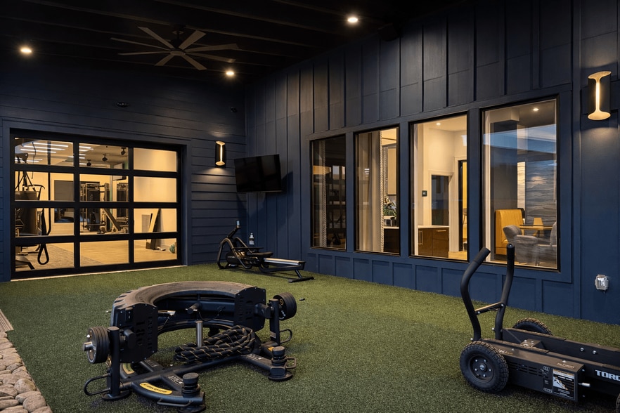Open the roll-up door to extend your workout into the fresh air at Cypress Point. - Cypress Point