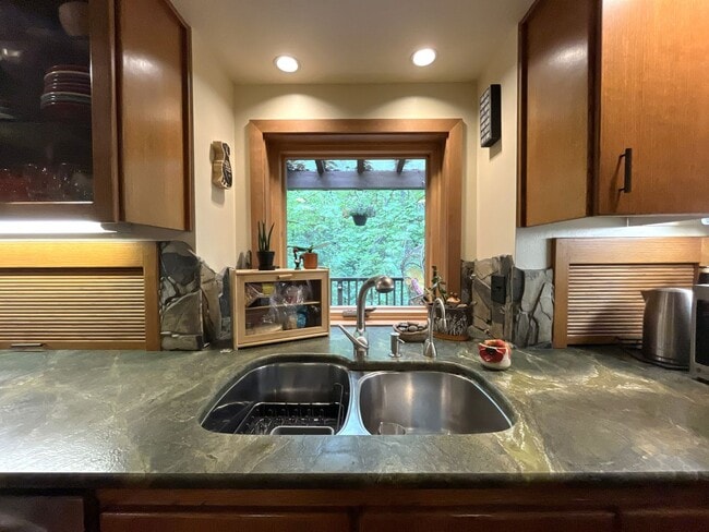Building Photo - One-of-a-Kind Custom Home with Wall of Windows, Stone Fireplaces, Expansive Entertainment Space &...