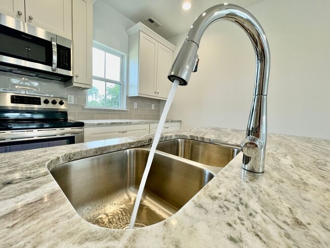 Building Photo - Practically New & Available NOW! Americana Luxury Townhomes! Pet Friendly! Attached Garage! All A...