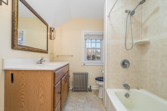 Updated bath with ceramic tile shower and floor - 317 Washburn Ave