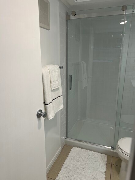 Frameless glass shower door - 625 S Royal Crest Cir
