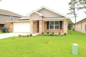 Building Photo - Coming Available Soon – 4BR/2BA Brick Home with Open Floor Plan, Solar Panels & 2-Car Garage in L...