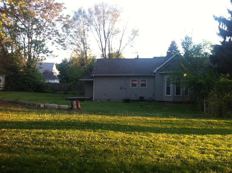 The backyard is smaller than shown here. This was taken from the neighbor’s yard. The side and back yard can be seen form the neighbor's in this view however there is a fence that encloses the space now. - 1445 South Center Street