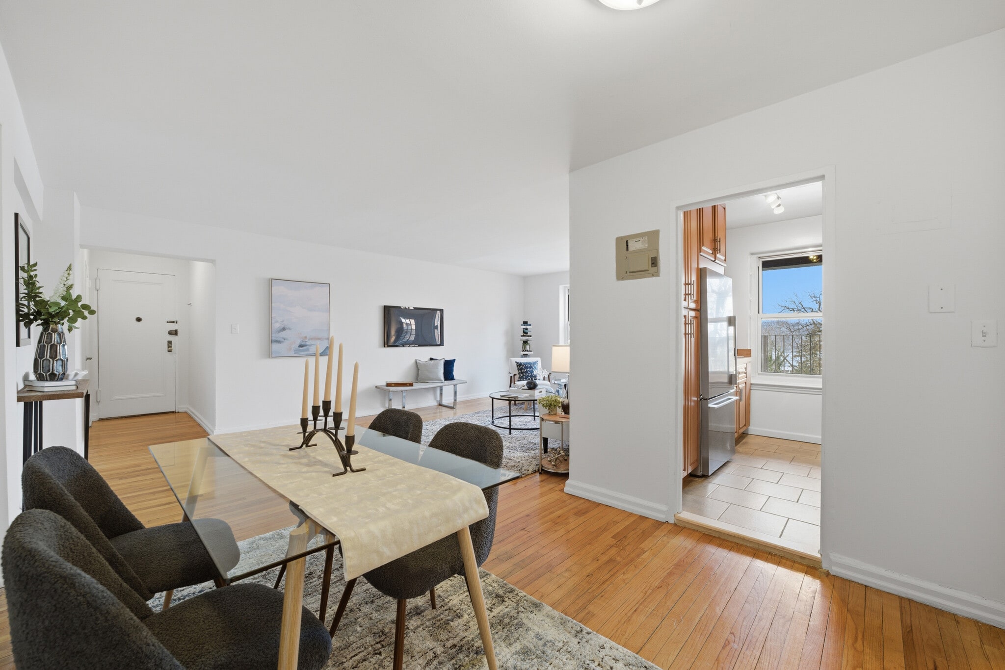 Dining area featuring hardwood floors with convenient access to the kitchen. - 555 Broadway