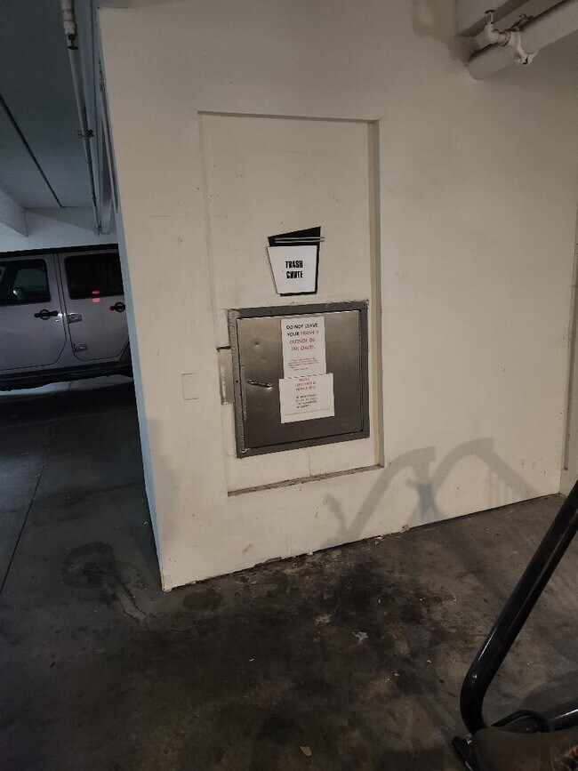 Trash disposal in garage next to condo entrance - 1701 E Colter St