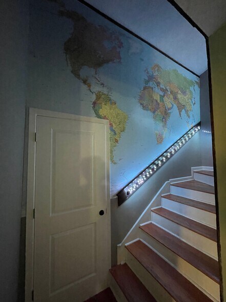 world map in stairwell - 8100 Red Willow Dr