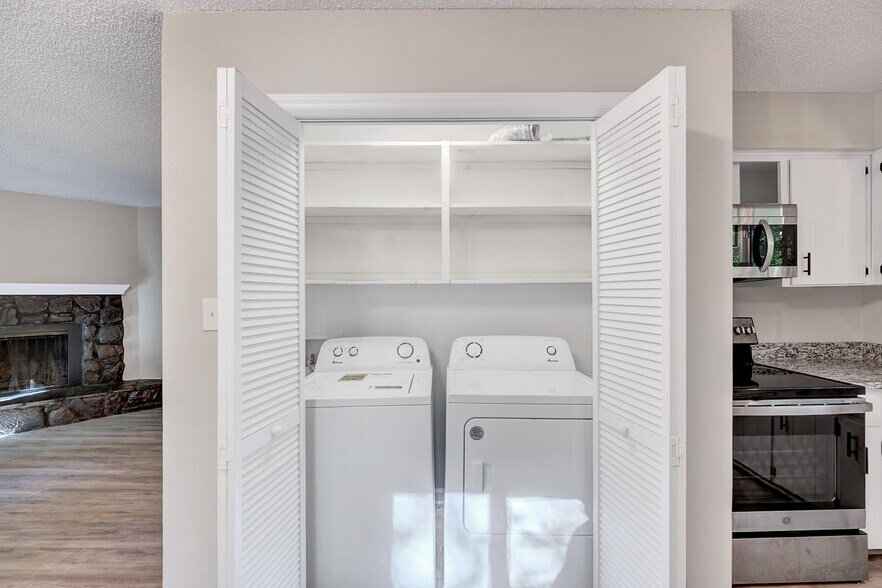 Washer and dryer + storage are next to the kitchen - 4115 Arckelton Dr