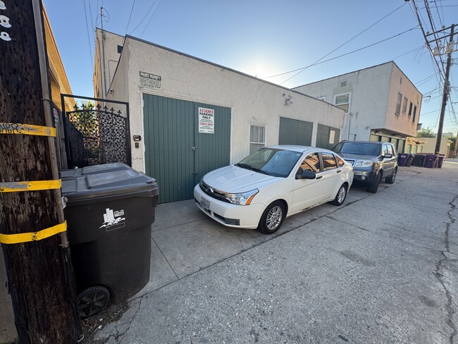 Optional garage (on left) and parking space (where white car is parked). - 1749 E 3rd St