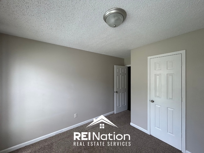 Building Photo - Spacious 4BR/2BA Near Southwind | High Ceilings, Brick Fireplace & 2-Car Garage