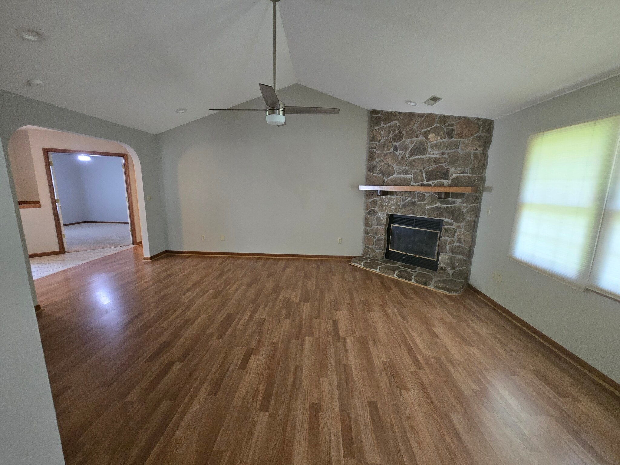 Living room view with fireplace and ceiling fan - 3700 Falmouth Dr