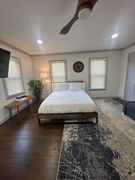 Relax in this cozy downstairs bedroom featuring a plush double bed and peaceful ambiance. - 5460 Scofield Rd