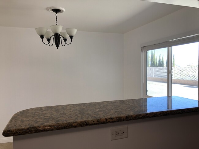 view toward dining room from a small bar in kitchen - 1214 N Park Western Dr