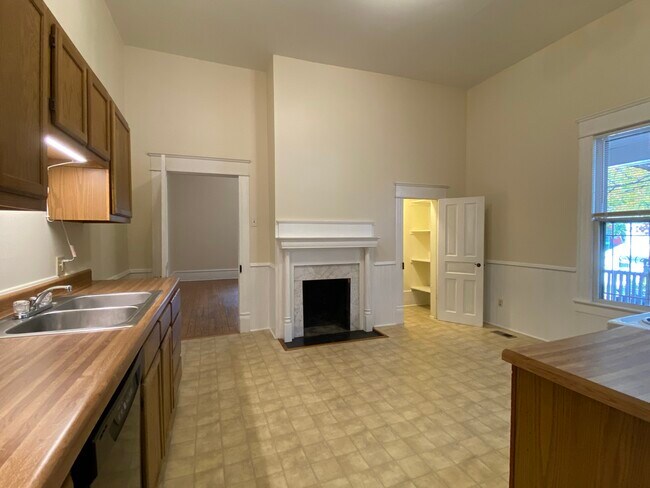 The eat-in kitchen includes a pantry and decorative fireplace. - 218 Linden Ave