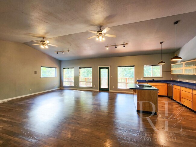 Building Photo - Vaulted Ceilings, Unique Designer Kitchen & Expansive Half-Acre Setting with Flexible Living Spaces