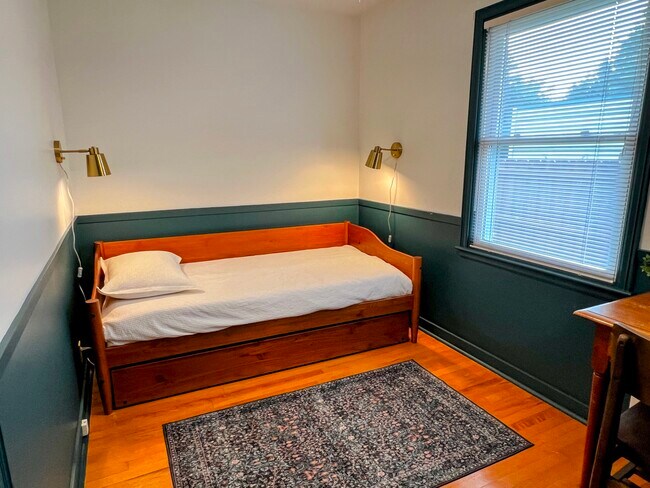 The middle bedroom has a daybed with a trundle. The main floor of the house can sleep up to six. - 228 W Lexington Blvd