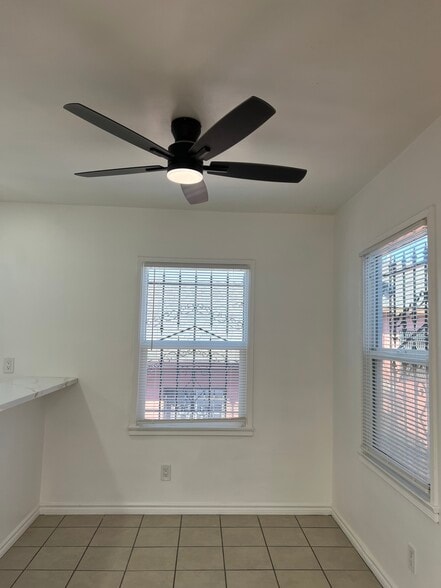 Dining area with large windows that invite a refreshing breeze, complemented by a remote-controlled - 3551 W Manchester Blvd