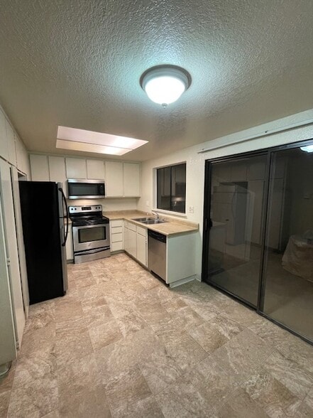 Kitchen with sliding doors leading to the private patio - 5 Del Prado Cir